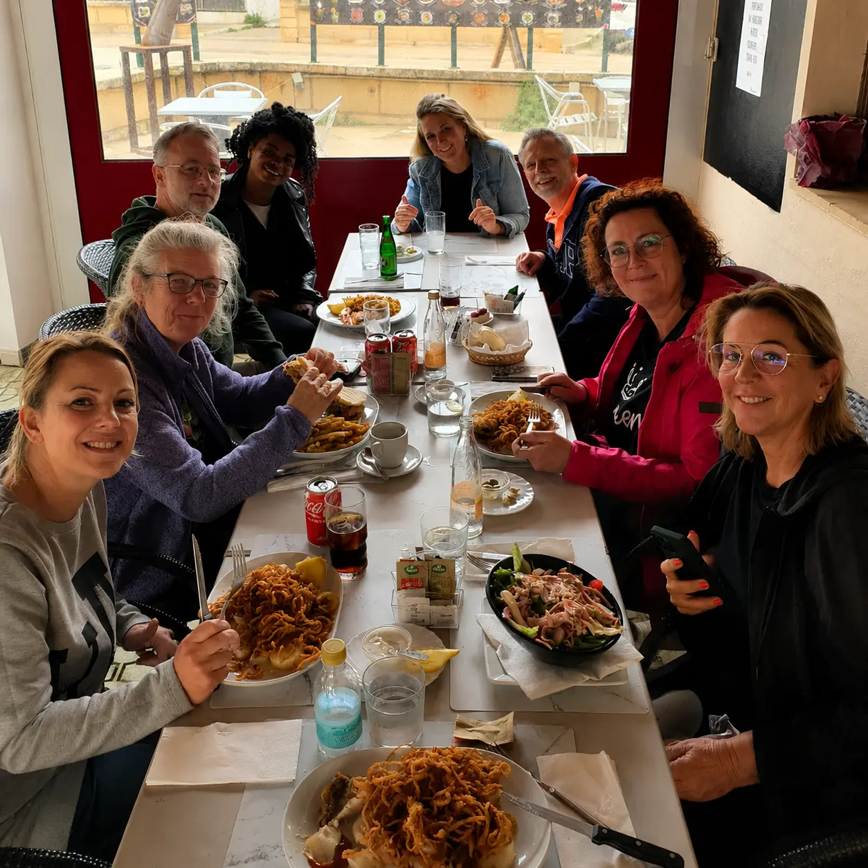 The group sharing a long lunch together around one table